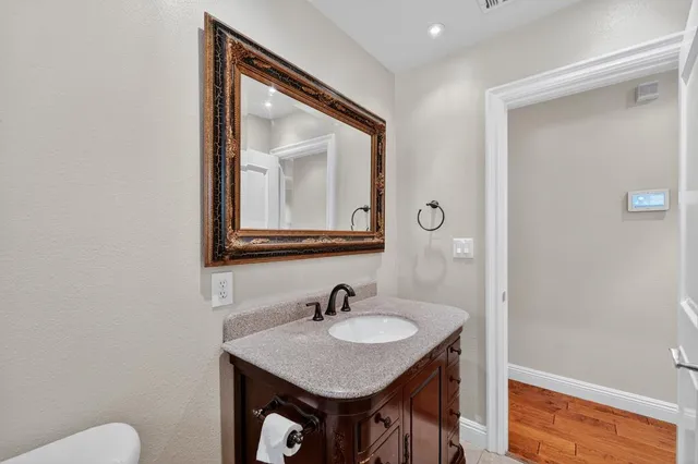 a bathroom with a sink vanity and a mirror