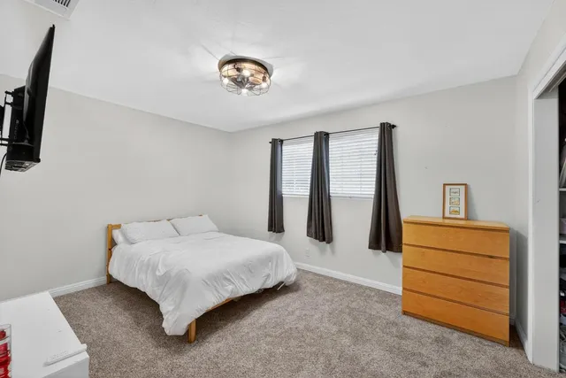 a bedroom with a bed and a dresser