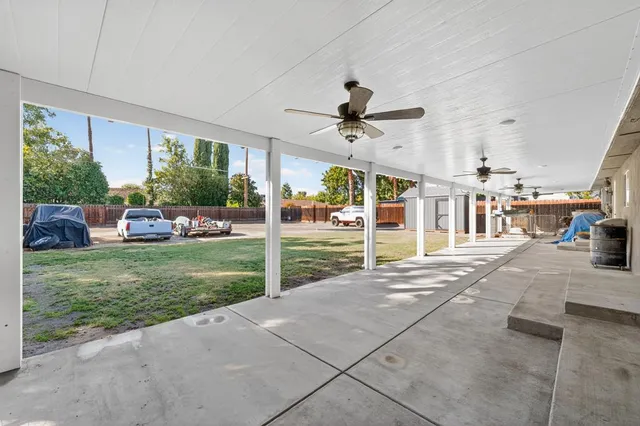 a view of a porch with furniture and garden