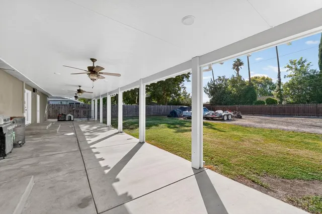 a view of a house with backyard and porch
