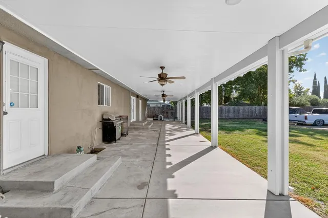 a view of a porch with furniture and garden