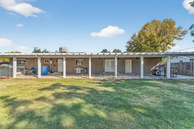 a view of a house with a yard and sitting area