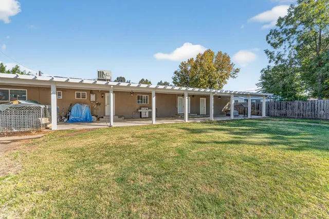 a view of a house with a backyard