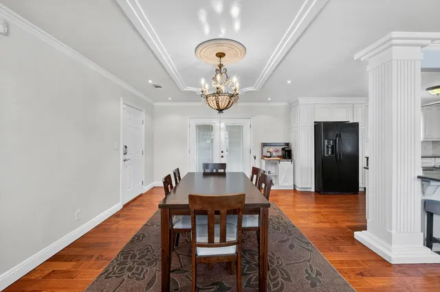 a view of a dining room with furniture and chandelier