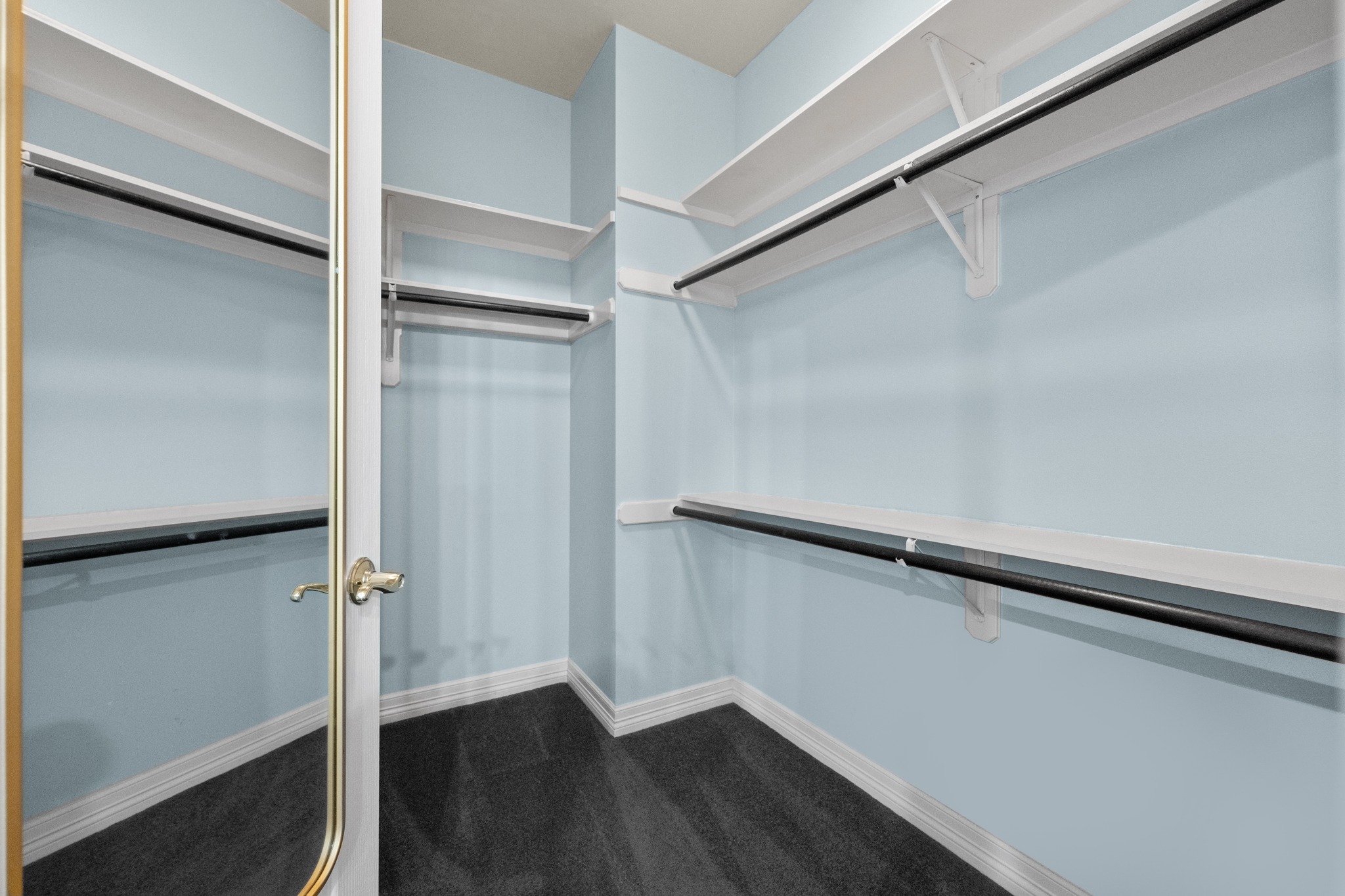 6004 Mt Bonnell Road Austin, TX 78731 - Photo 17 of 24 a view of walk in closet with wooden floor