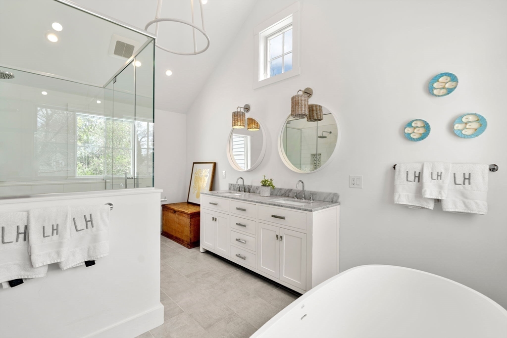 28 Rose Avenue Marblehead, MA 01945 - Photo 18 of 31 a spacious bathroom with a tub sink and mirror