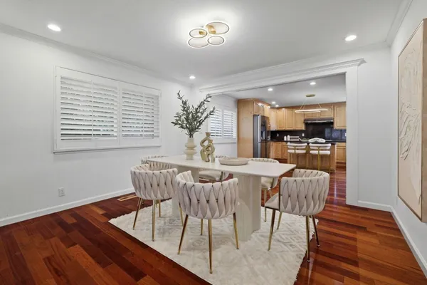 a view of a dining room with furniture window and wooden floor
