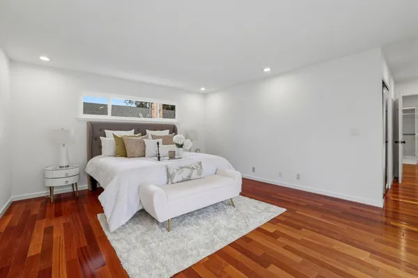 a bedroom with a bed and wooden floor
