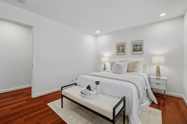 a bedroom with a bed and wooden floor