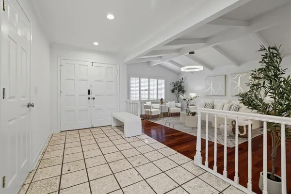 a spacious bathroom with mirror and tiles flooring