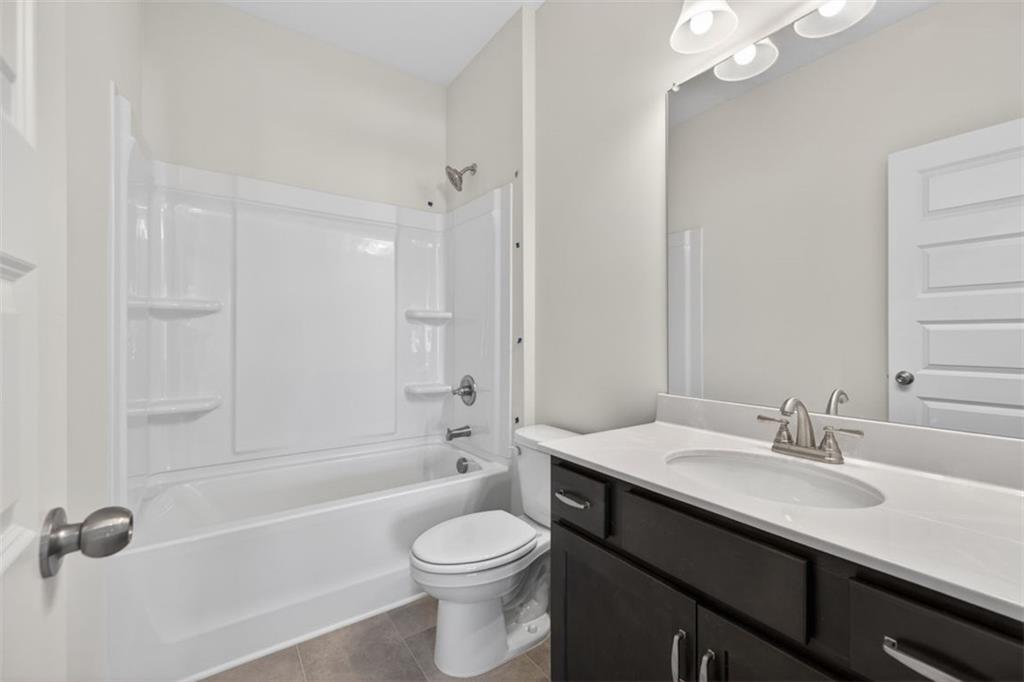 224 Bastian Drive, Unit 116 Villa Rica, GA 30180 - Photo 21 of 33 a bathroom with a sink a toilet and shower