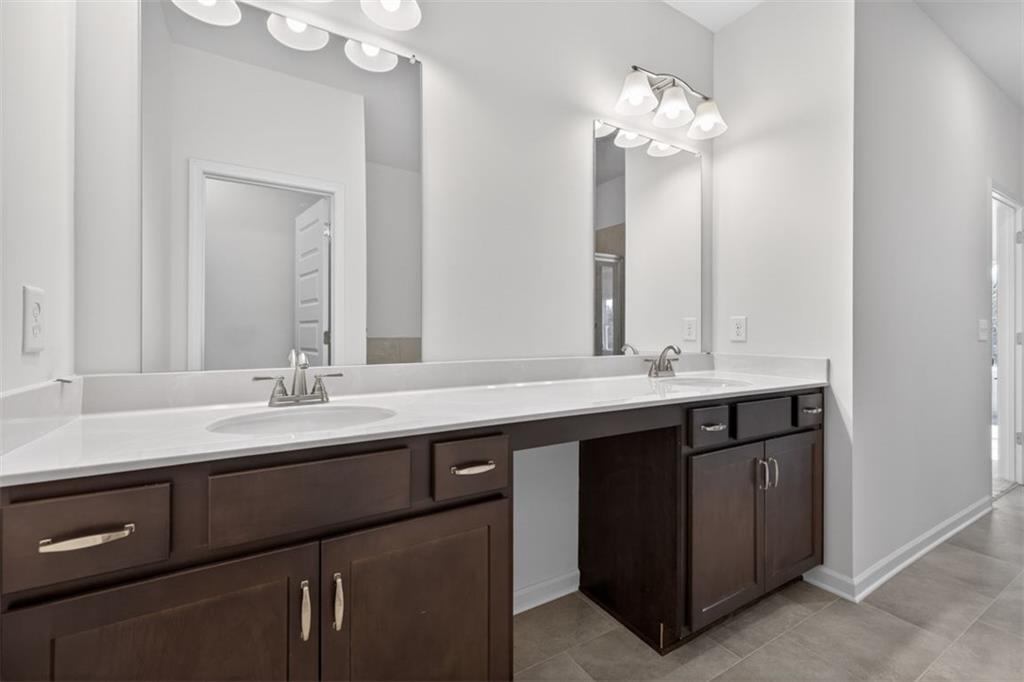 224 Bastian Drive, Unit 116 Villa Rica, GA 30180 - Photo 30 of 33 a bathroom with a double vanity sink and a mirror