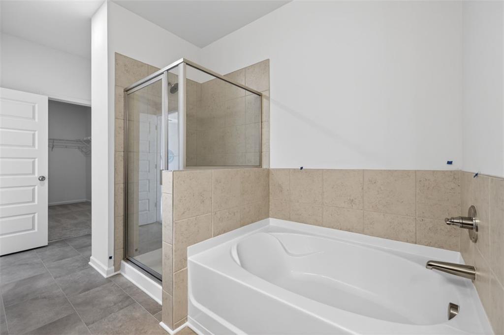 224 Bastian Drive, Unit 116 Villa Rica, GA 30180 - Photo 31 of 33 a bathroom with a tub and shower