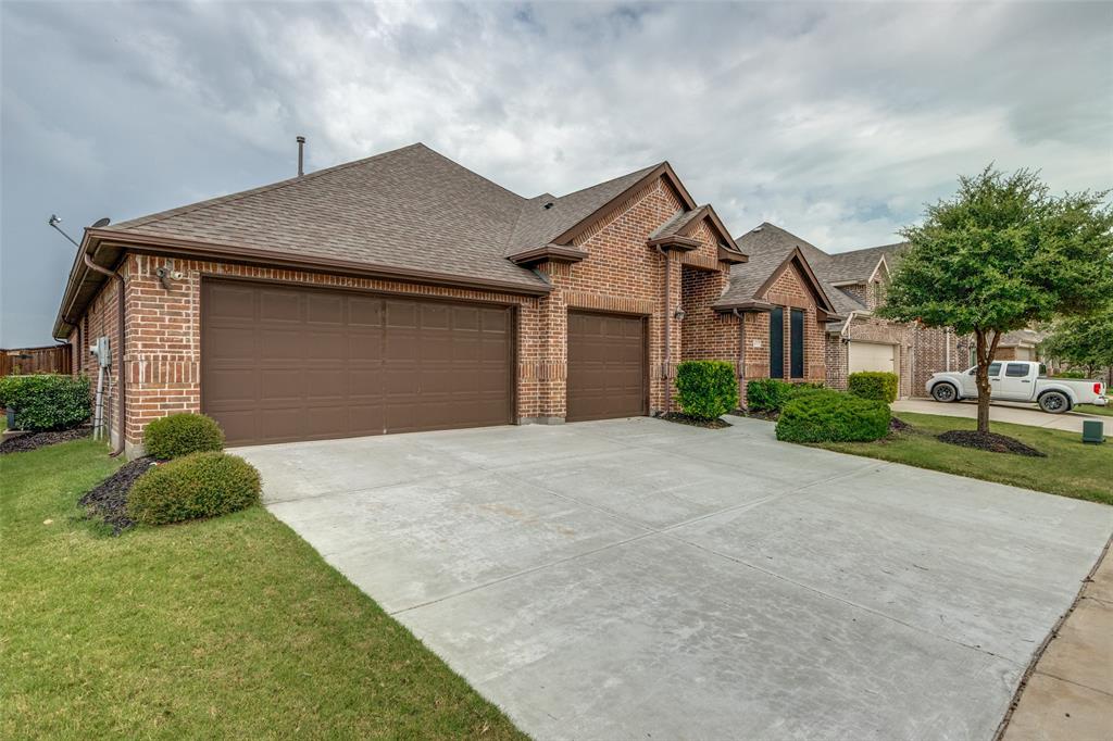 4217 Switchgrass Street Celina, TX 75009 - Photo 2 of 25 a front view of a house with a yard and garage