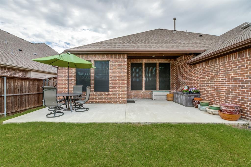 4217 Switchgrass Street Celina, TX 75009 - Photo 22 of 25 a view of a patio with table and chairs and potted plants