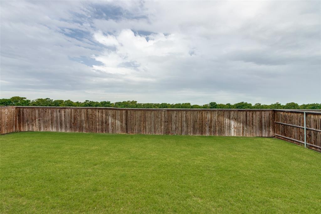 4217 Switchgrass Street Celina, TX 75009 - Photo 24 of 25 a view of a yard with wooden fence