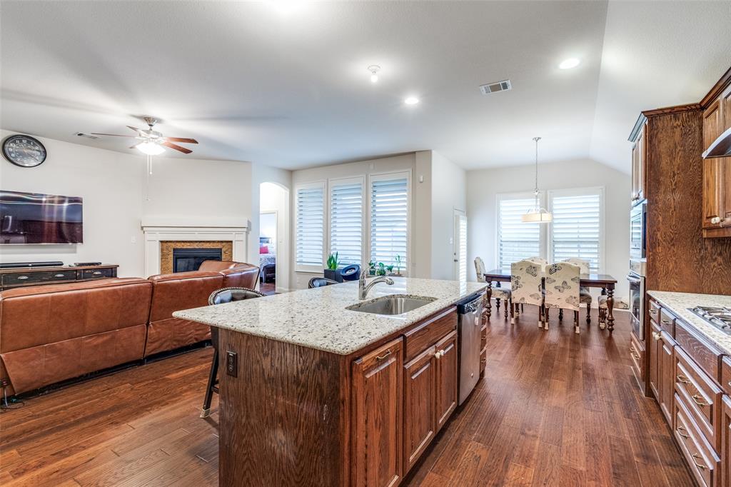 4217 Switchgrass Street Celina, TX 75009 - Photo 9 of 25 a kitchen with sink dining table and chairs