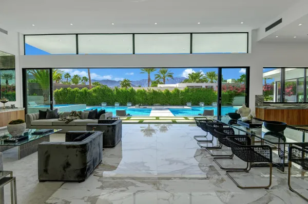 a view of a kitchen with kitchen island a large window in it