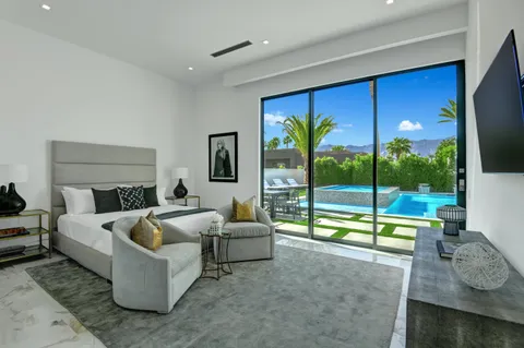 a living room with furniture and a floor to ceiling window