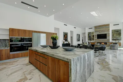 a kitchen with lots of counter top space sink and stainless steel appliances