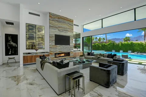 a living room with fireplace furniture and a flat screen tv