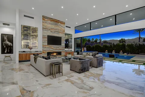 a view of living room with kitchen island furniture and a flat screen tv