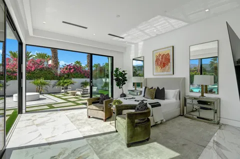 a living room with furniture and a floor to ceiling window