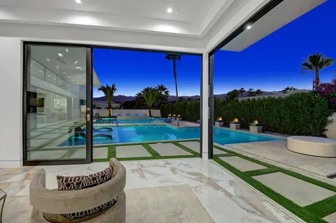 a swimming pool with outdoor seating and yard