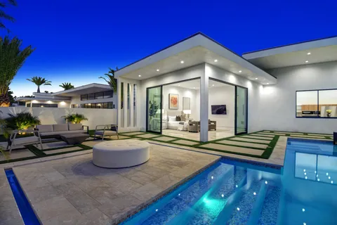 a swimming pool with outdoor seating and yard