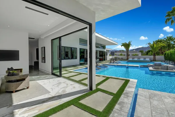 a view of swimming pool with outdoor seating