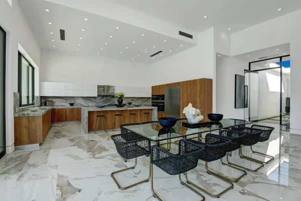 a kitchen with stainless steel appliances kitchen island granite countertop a sink and cabinets