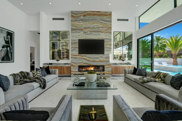 a living room with furniture flat screen tv and a fireplace