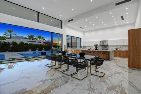 a living room with lots of furniture and kitchen view