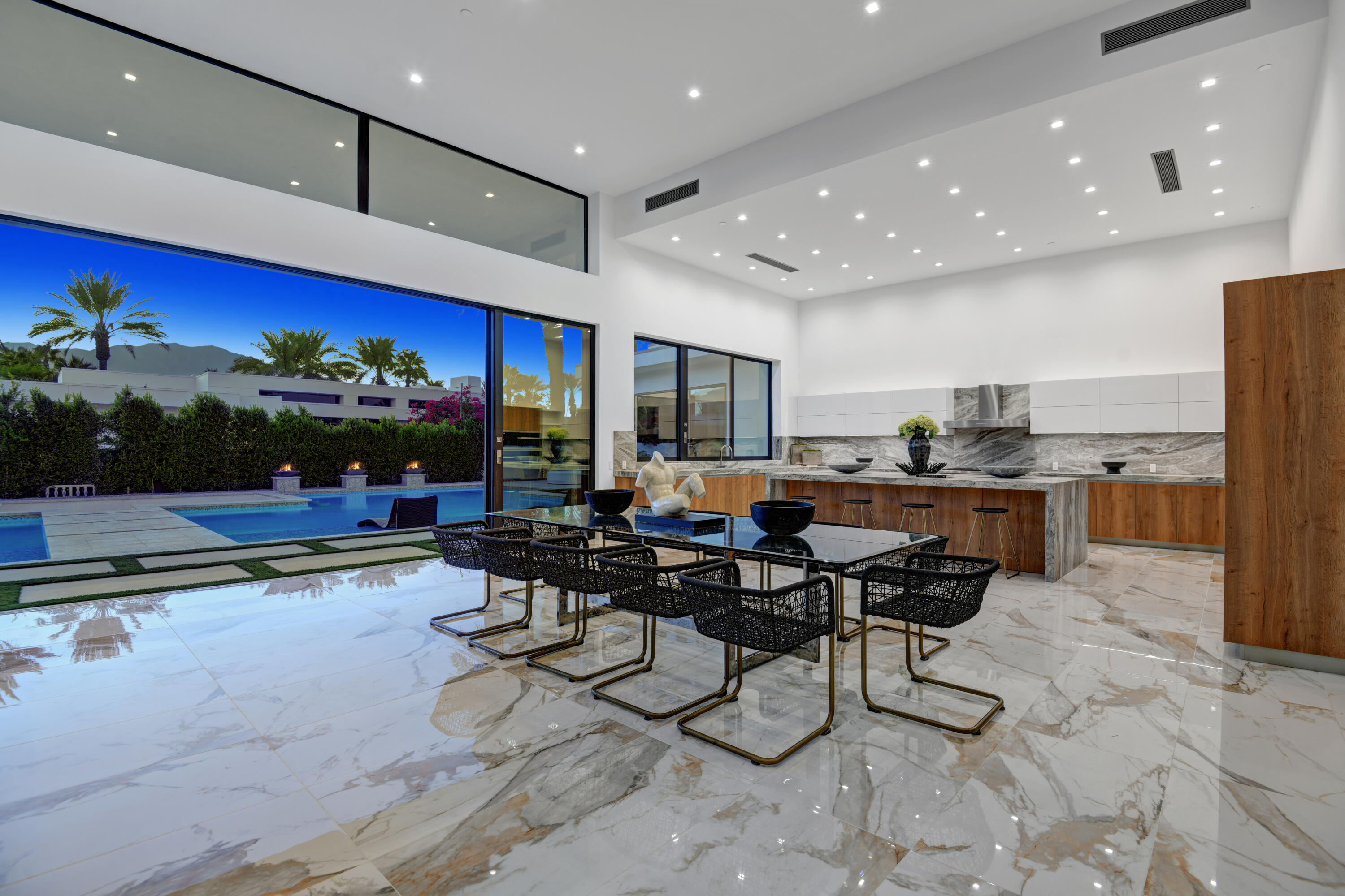3 Bravo Court Rancho Mirage, CA 92270 - Photo 10 of 40 DINING ROOM TO KITCHEN AND POOL NIGHT