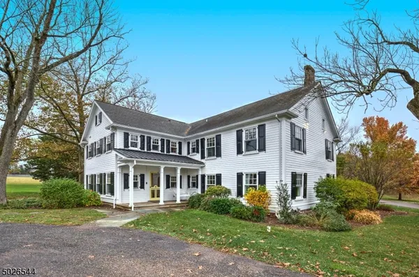 a view of house with yard and green space