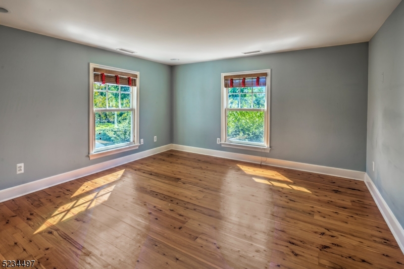 1815 Burnt Mills Road Bedminster, NJ 07921 - Photo 23 of 27 a view of an empty room with wooden floor and a window
