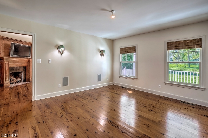 1815 Burnt Mills Road Bedminster, NJ 07921 - Photo 9 of 27 an empty room with wooden floor and windows