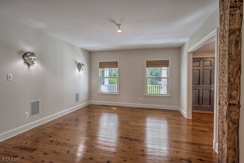 1815 Burnt Mills Road Bedminster, NJ 07921 - Photo 10 of 27 a view of empty room with wooden floor and fan