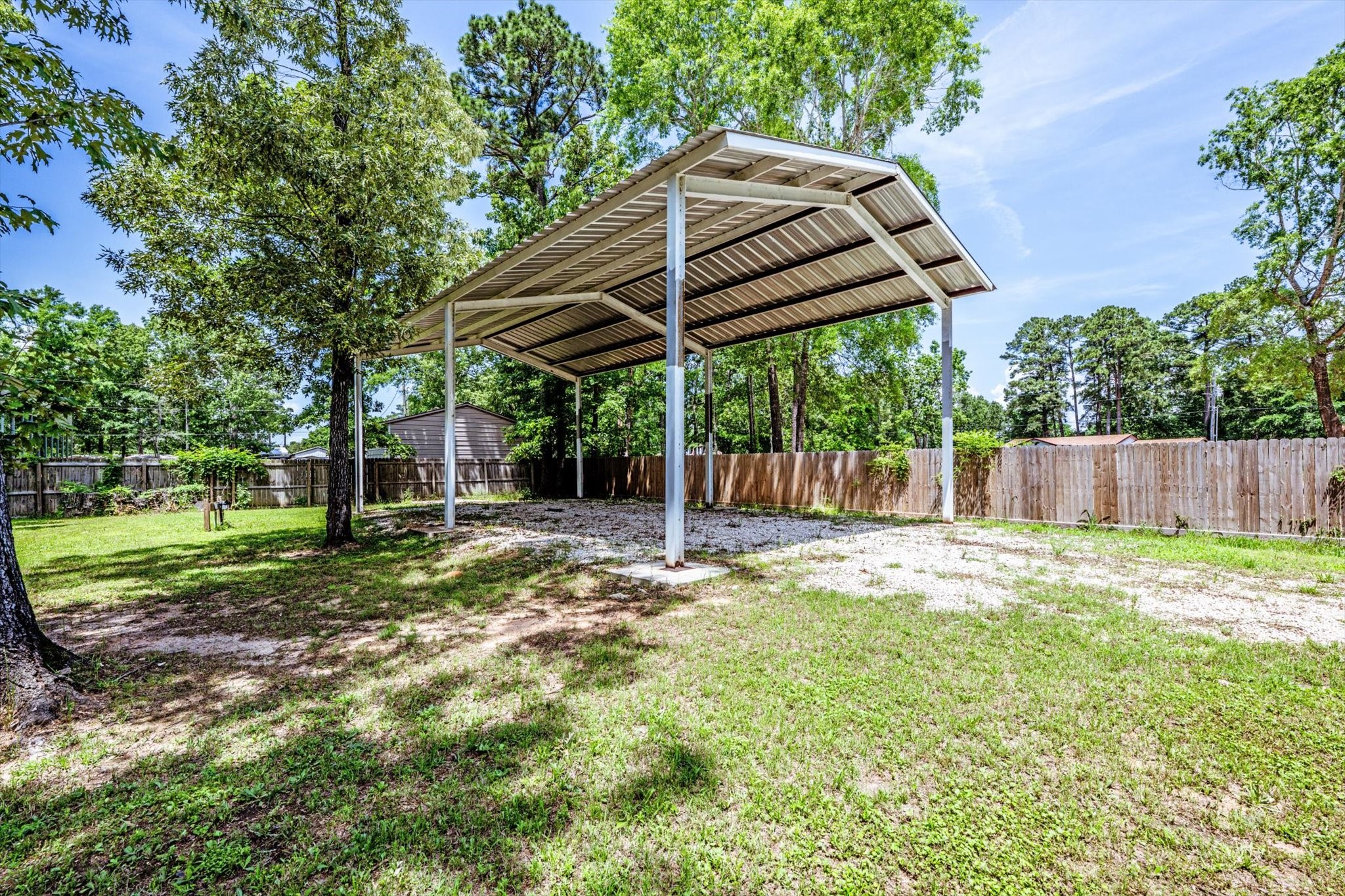 50 Canary Street Point Blank, TX 77364 - Photo 11 of 33 a view of a backyard with table and chairs under an umbrella