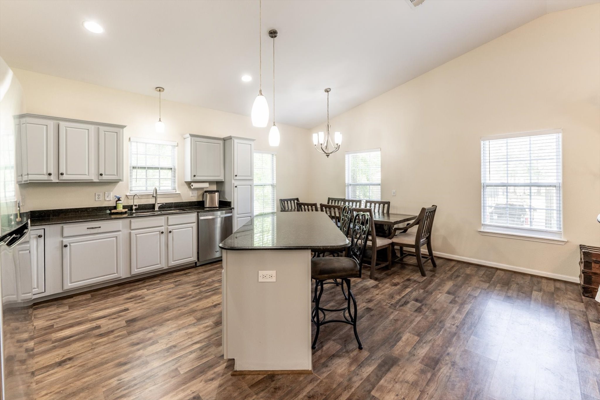 50 Canary Street Point Blank, TX 77364 - Photo 15 of 33 a kitchen with stainless steel appliances kitchen island granite countertop a sink cabinets and wooden floor