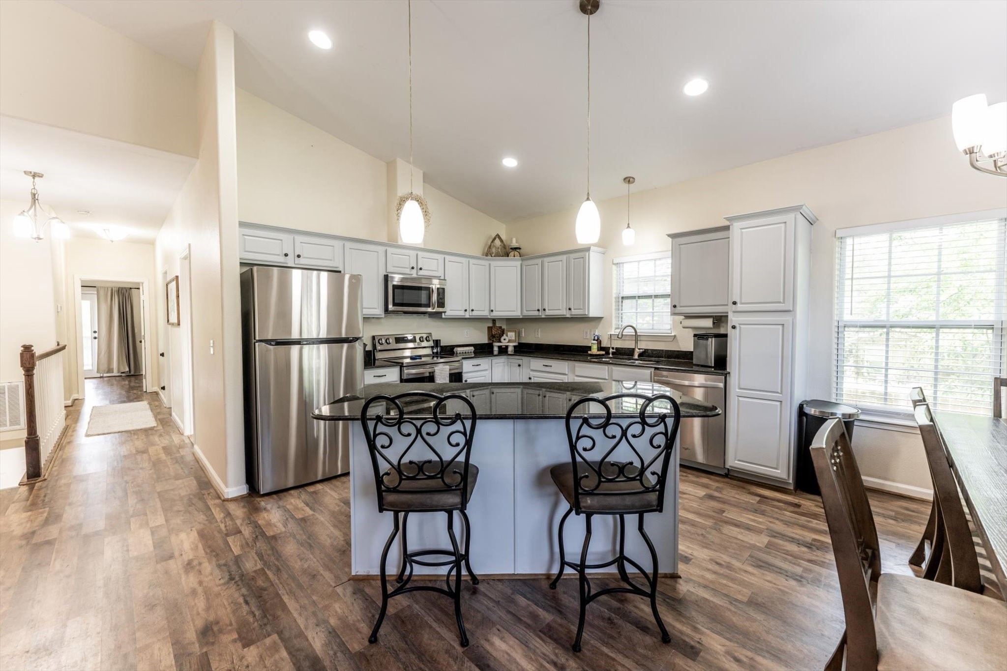 50 Canary Street Point Blank, TX 77364 - Photo 17 of 33 a kitchen with stainless steel appliances a dining table chairs refrigerator microwave and cabinets