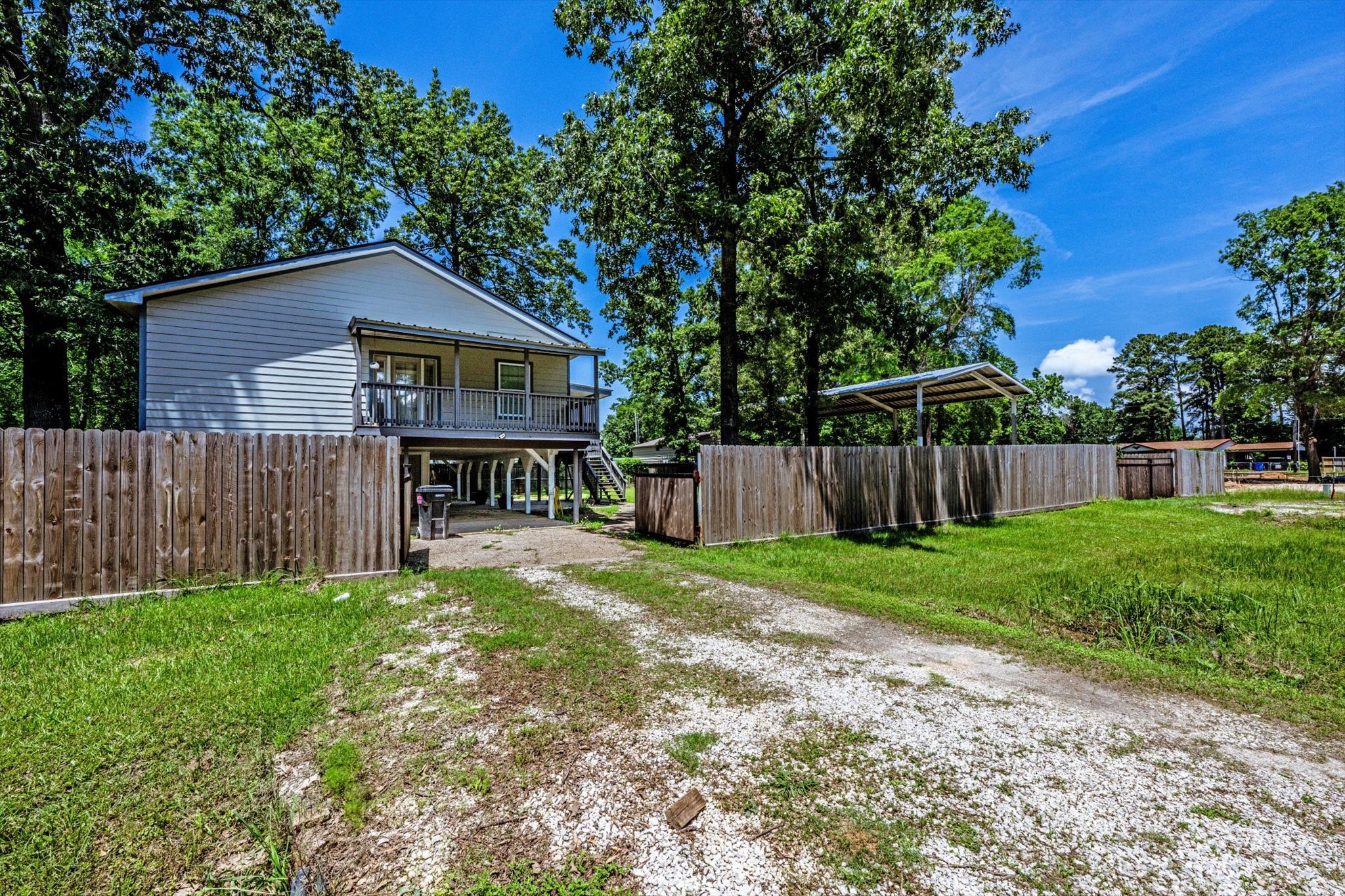 50 Canary Street Point Blank, TX 77364 - Photo 2 of 33 a view of a yard with a house and a large tree