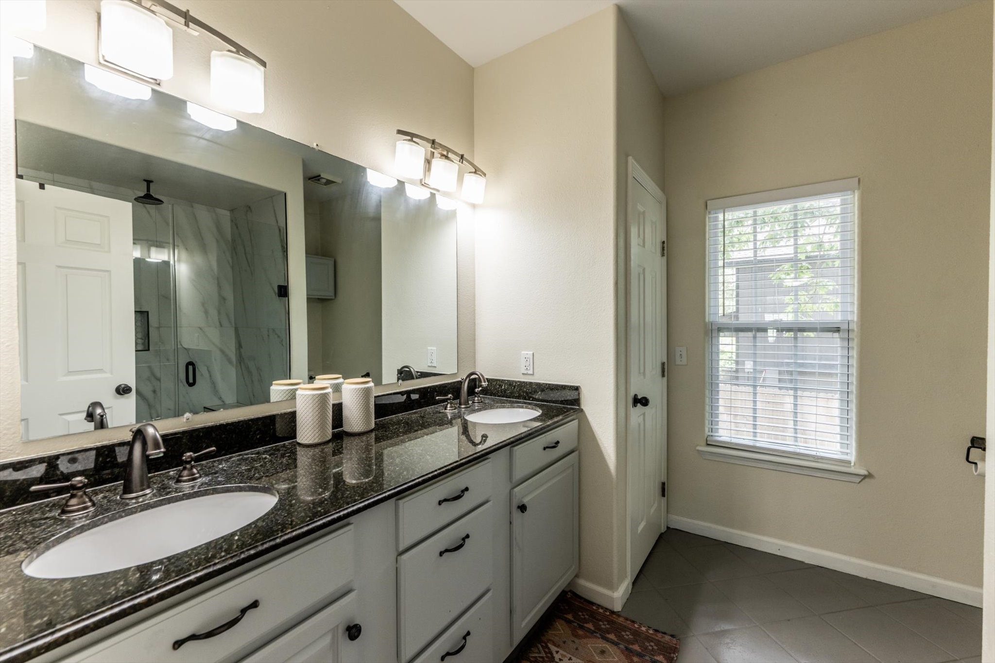 50 Canary Street Point Blank, TX 77364 - Photo 21 of 33 a spacious bathroom with a granite countertop sink a mirror a and a window