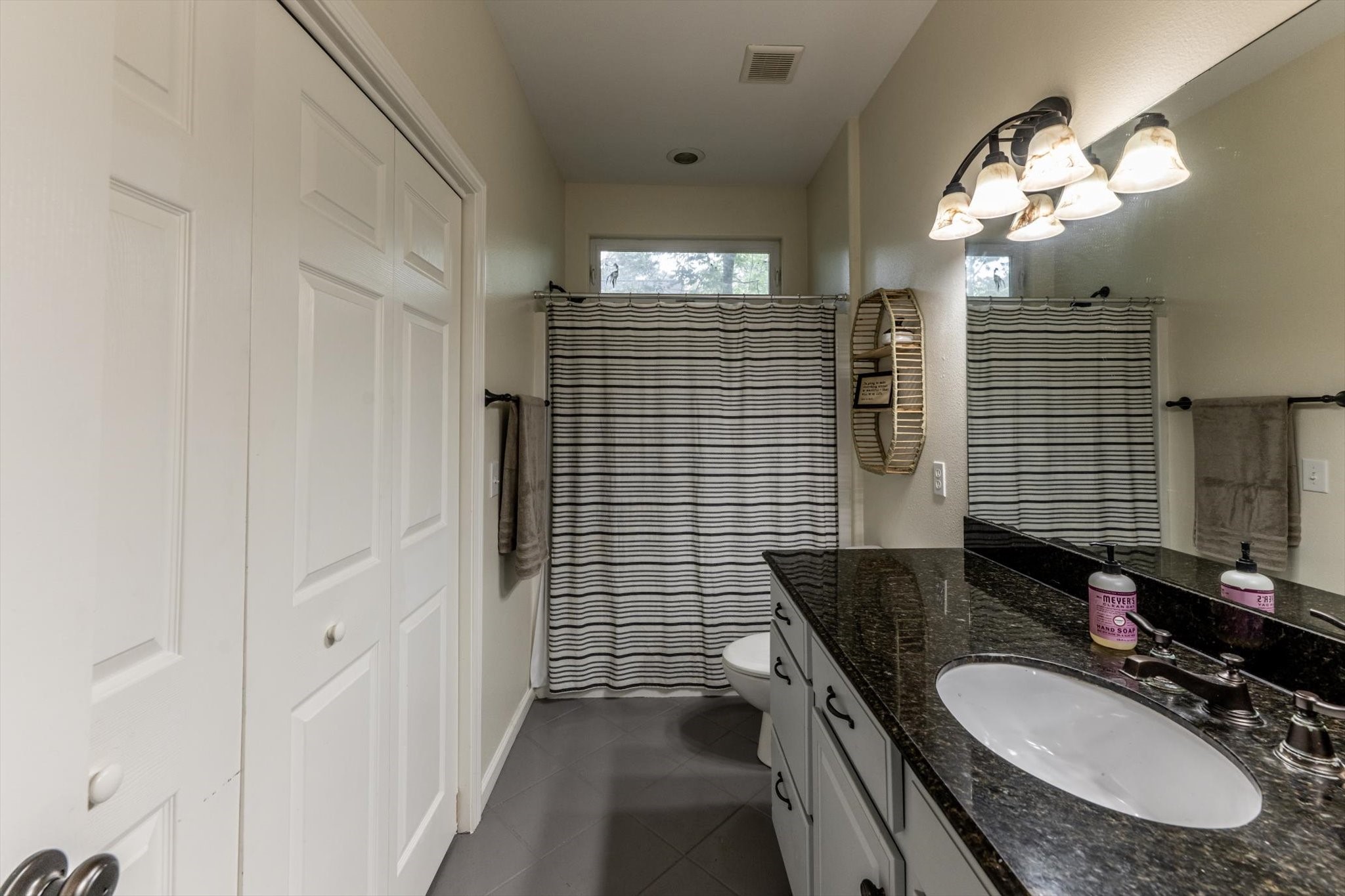 50 Canary Street Point Blank, TX 77364 - Photo 27 of 33 a bathroom with a sink a vanity a mirror and a shower