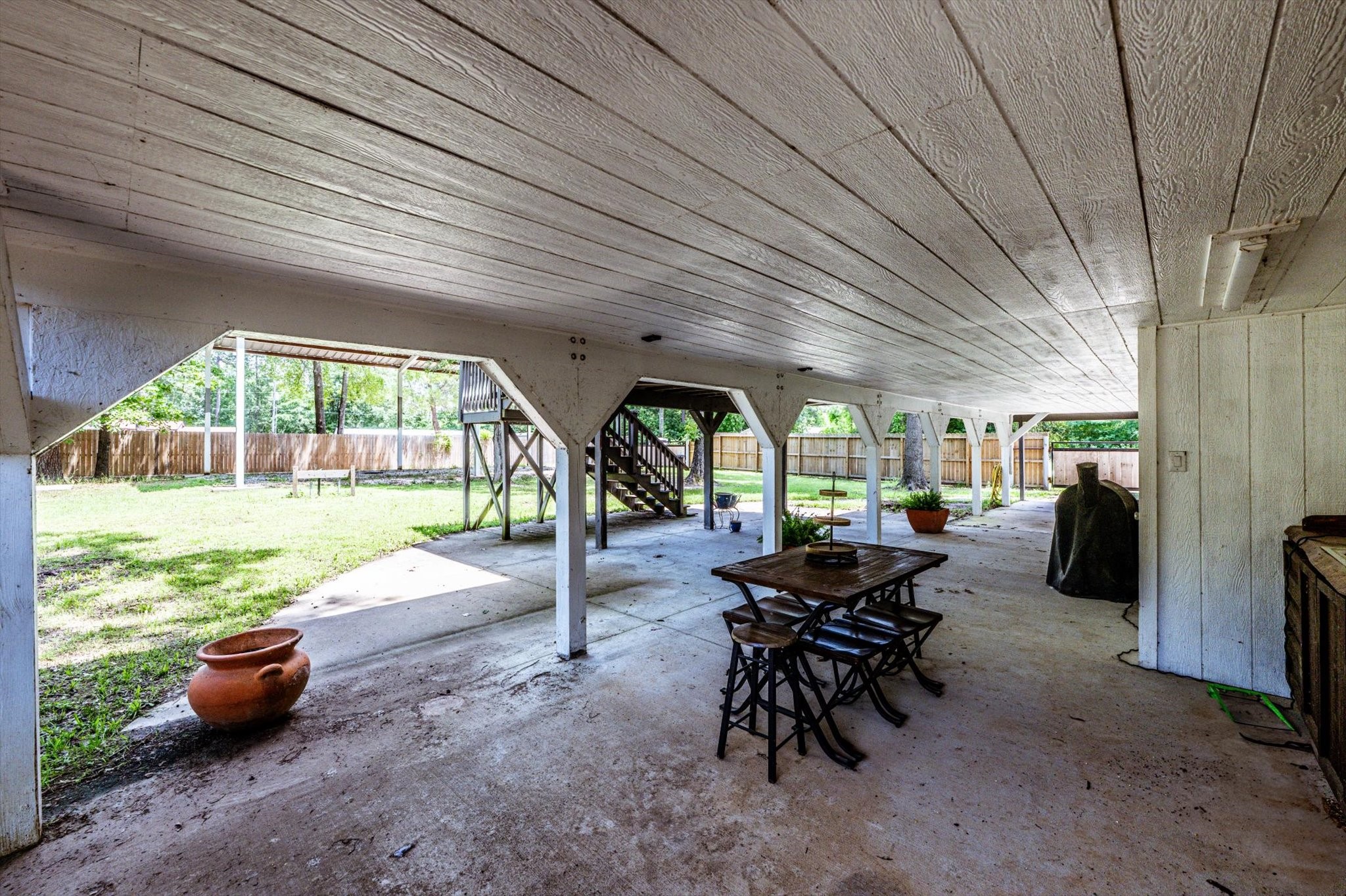 50 Canary Street Point Blank, TX 77364 - Photo 28 of 33 a view of a patio with table and chairs and potted plants