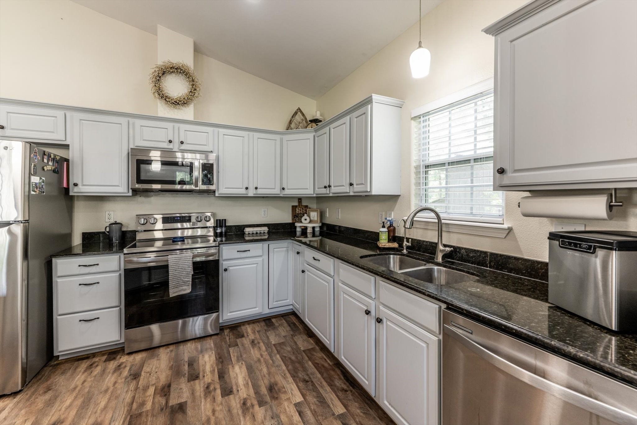 50 Canary Street Point Blank, TX 77364 - Photo 5 of 33 a kitchen with stainless steel appliances granite countertop a sink and stove top oven