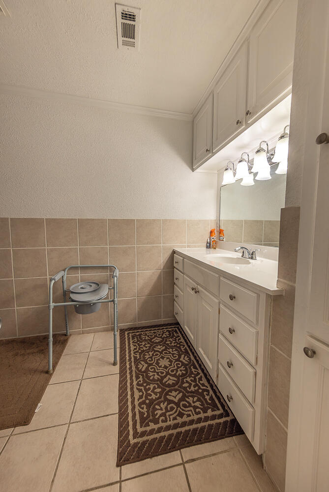 1724 East 2nd Street Lubbock, TX 79403 - Photo 12 of 20 a bathroom with a sink and a mirror