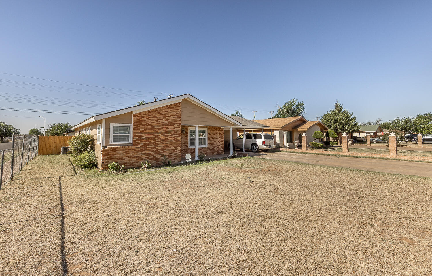 1724 East 2nd Street Lubbock, TX 79403 - Photo 19 of 20 a front view of a house with a yard and garage