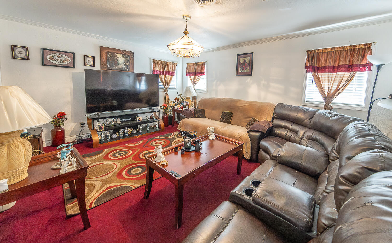 1724 East 2nd Street Lubbock, TX 79403 - Photo 2 of 20 a living room with furniture a flat screen tv and a window