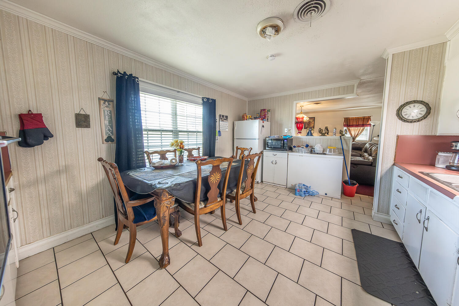 1724 East 2nd Street Lubbock, TX 79403 - Photo 5 of 20 a kitchen with a dining table chairs and a refrigerator